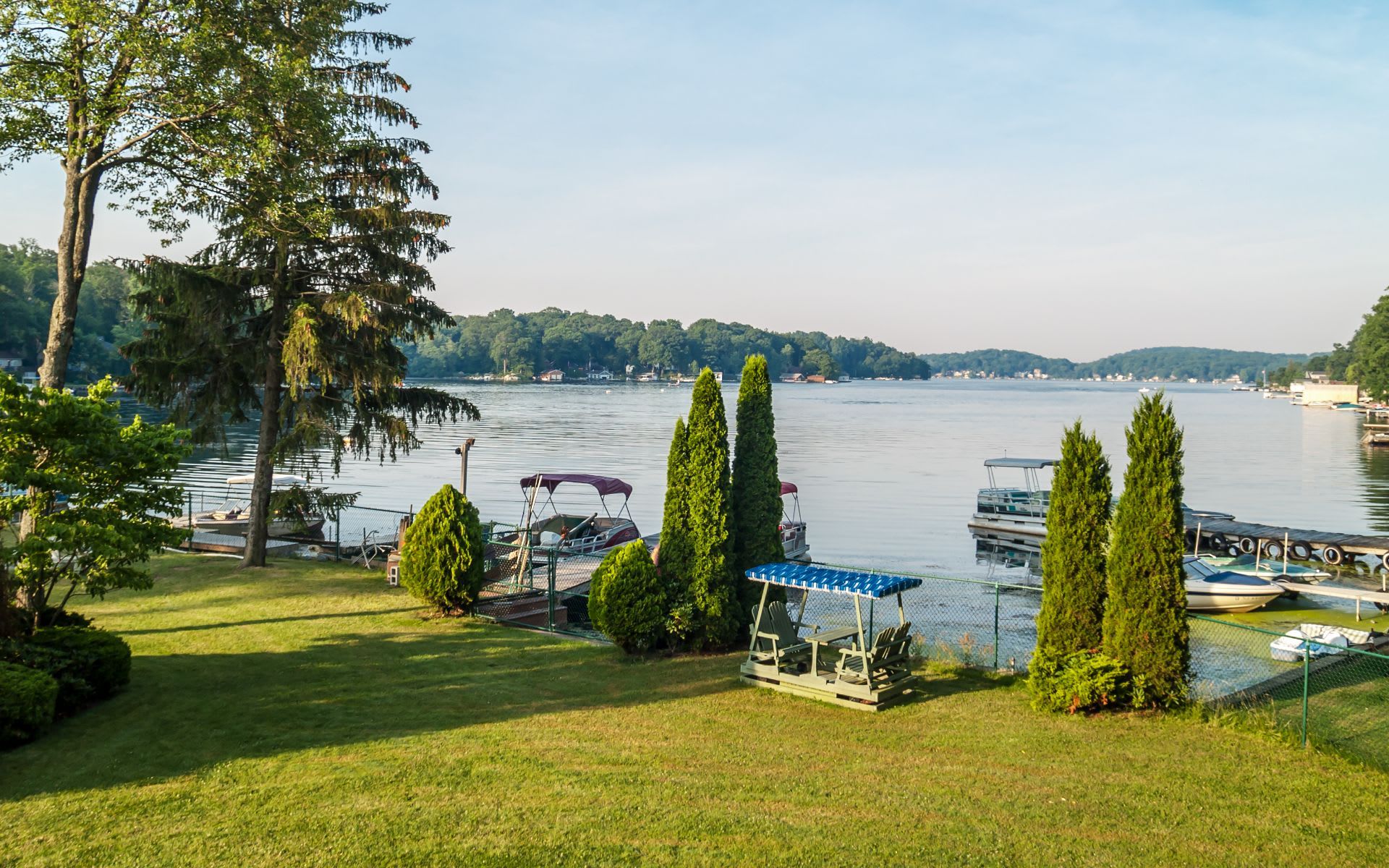 A lakeside lawn with boat docks