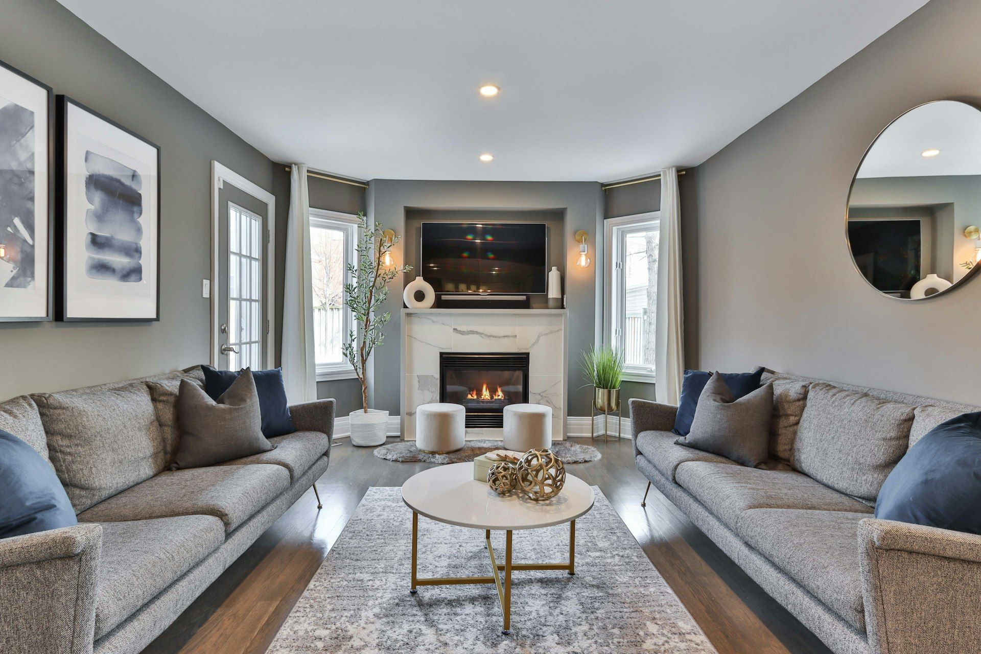 A living room with a fireplace and sofas